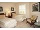 Bedroom with twin beds, nightstand, and wicker chair at 2620 Tarpon Cove Dr # 311, Punta Gorda, FL 33950