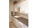 Well-equipped laundry room featuring a utility sink and extensive cabinetry at 2620 Tarpon Cove Dr # 311, Punta Gorda, FL 33950
