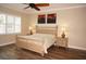 Bright bedroom with king-size bed, nightstands, and plantation shutters at 2620 Tarpon Cove Dr # 311, Punta Gorda, FL 33950