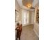 Bright entryway with tile flooring, wood accent table, and double French doors at 2620 Tarpon Cove Dr # 311, Punta Gorda, FL 33950