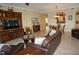 Living room with leather sofas, wood entertainment center, and open layout at 2620 Tarpon Cove Dr # 311, Punta Gorda, FL 33950
