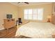 Bedroom with king-size bed, dresser, TV, and plantation shutters at 2620 Tarpon Cove Dr # 311, Punta Gorda, FL 33950