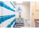 Bathroom with a toilet, sink, and blue and white striped shower curtain at 335 Harbor Blvd, Port Charlotte, FL 33954