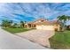 Two-story house with a paved driveway and lush landscaping at 3736 Bordeaux Dr, Punta Gorda, FL 33950