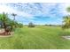 Spacious backyard with lush lawn and golf course view at 3736 Bordeaux Dr, Punta Gorda, FL 33950
