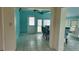 Dining area with teal walls, tiled floor, and access to outdoor space at 3767 Peace River Dr, Punta Gorda, FL 33983