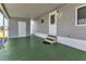 Covered patio with access to the home and storage at 6450 Floral Ct, North Port, FL 34287