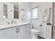 Clean bathroom with white vanity, toilet, and shower at 6450 Floral Ct, North Port, FL 34287