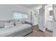 Bright bedroom featuring a daybed, en-suite bathroom access, and wood-look floors at 6450 Floral Ct, North Port, FL 34287