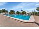 Community pool with brick deck and lounge chairs at 6450 Floral Ct, North Port, FL 34287