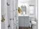 Bathroom with gray vanity, toilet and shower/tub combo at 6450 Floral Ct, North Port, FL 34287