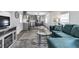 Living room features teal sectional sofa and glass coffee table at 6450 Floral Ct, North Port, FL 34287