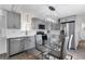 Modern kitchen with gray cabinets, stainless steel appliances, and quartz countertops at 6450 Floral Ct, North Port, FL 34287