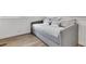 Cozy bedroom with a gray daybed and light wood flooring at 6450 Floral Ct, North Port, FL 34287
