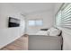 Bedroom with gray daybed and large windows with blinds at 6450 Floral Ct, North Port, FL 34287