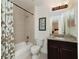 Guest bathroom with tub shower combination and granite vanity at 88 Vivante Blvd # 8845/405, Punta Gorda, FL 33950