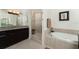Elegant bathroom with a soaking tub, shower, and granite vanity at 88 Vivante Blvd # 8845/405, Punta Gorda, FL 33950
