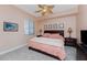 Guest bedroom with king-size bed and ceiling fan at 88 Vivante Blvd # 8845/405, Punta Gorda, FL 33950