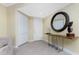 Bright and airy entryway with tile flooring, built-in shelving and large mirror at 88 Vivante Blvd # 8845/405, Punta Gorda, FL 33950