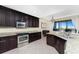 Modern kitchen with granite countertops and stainless steel appliances at 88 Vivante Blvd # 8845/405, Punta Gorda, FL 33950