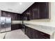 Modern kitchen featuring stainless steel appliances and dark wood cabinets at 88 Vivante Blvd # 8845/405, Punta Gorda, FL 33950