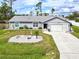 Aerial view of a single-story house with a well-maintained lawn at 12075 Appleberg Cir, Port Charlotte, FL 33981