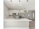 Open concept kitchen with large island, stainless steel appliances, and white cabinets at 1430 Nora Ln, North Port, FL 34286