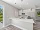Modern kitchen with island, stainless steel appliances, and white cabinets at 1430 Nora Ln, North Port, FL 34286