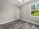 Bright bedroom with wood-look floors and a window at 1430 Nora Ln, North Port, FL 34286