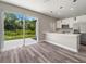Open kitchen features island, stainless steel appliances, and sliding glass door to backyard at 1430 Nora Ln, North Port, FL 34286