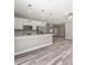Open concept kitchen with island, stainless steel appliances and gray walls at 1430 Nora Ln, North Port, FL 34286
