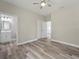 Bedroom with wood-look floors and access to bathroom at 1430 Nora Ln, North Port, FL 34286