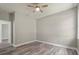 Simple bedroom with wood-look floors and ceiling fan at 1430 Nora Ln, North Port, FL 34286