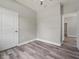 Spacious bedroom with wood-look floors and door to hallway at 1430 Nora Ln, North Port, FL 34286