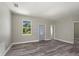 Bright living room with wood-look floors and front door at 1430 Nora Ln, North Port, FL 34286