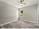 Bright bedroom with wood-look floors and a window at 1430 Nora Ln, North Port, FL 34286