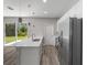 Modern kitchen with island, stainless steel appliances and sliding glass door at 1430 Nora Ln, North Port, FL 34286