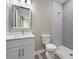 Modern bathroom with white vanity, shower, and updated fixtures at 1430 Nora Ln, North Port, FL 34286