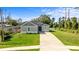 Two-story home with gray siding, and a well-maintained lawn at 1497 Nordendale Blvd, North Port, FL 34288