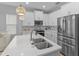 Modern kitchen with white cabinets and stainless steel appliances at 1497 Nordendale Blvd, North Port, FL 34288
