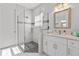 Modern bathroom with a walk-in shower, soaking tub, and white cabinets at 1497 Nordendale Blvd, North Port, FL 34288