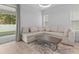 Living room with sectional sofa and sliding doors to patio at 1497 Nordendale Blvd, North Port, FL 34288