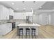 Spacious kitchen with island, white shaker cabinets, and stainless steel appliances at 1497 Nordendale Blvd, North Port, FL 34288