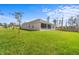 Spacious backyard with large grassy area and screened patio at 1497 Nordendale Blvd, North Port, FL 34288