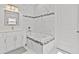 Elegant bathroom featuring a soaking tub, frameless shower, and white vanity at 1497 Nordendale Blvd, North Port, FL 34288