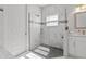 Spa-like bathroom with a walk-in shower and pebble flooring at 1497 Nordendale Blvd, North Port, FL 34288