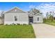 Gray house with white accents, landscaped lawn, and a paved driveway at 1497 Nordendale Blvd, North Port, FL 34288