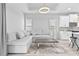 Bright living room featuring a sectional sofa and coffee table at 1497 Nordendale Blvd, North Port, FL 34288