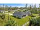 Aerial view of house and backyard, showcasing large grassy area and screened patio at 1497 Nordendale Blvd, North Port, FL 34288