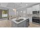 Modern kitchen with double sink, white cabinets, and stainless steel appliances at 1497 Nordendale Blvd, North Port, FL 34288